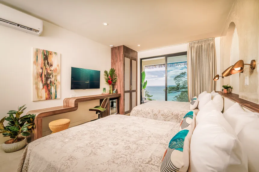 Two queen beds with ocean view in the Oceanfront Balcony Suite