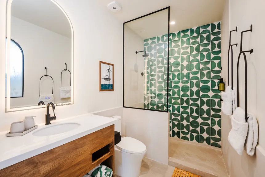 En-suite bathroom with green tile shower