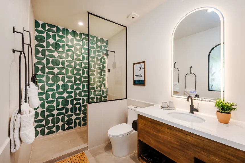 En-suite bathroom with green tile shower in the Oceanview Suite