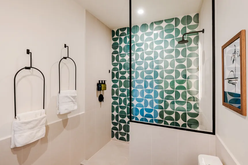Walk-in shower with green tile in the Oceanview Suite