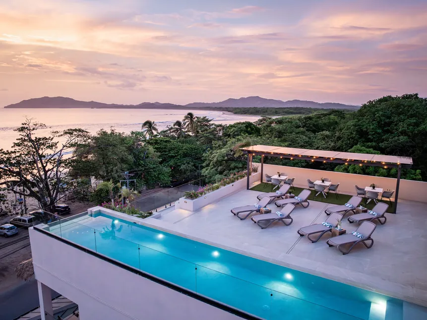 Rooftop infinity pool at sunset overlooking Tamarindo Bay