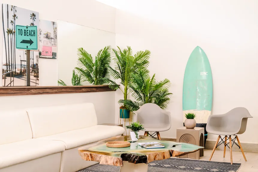 Lobby lounge with surfboard and tropical plants