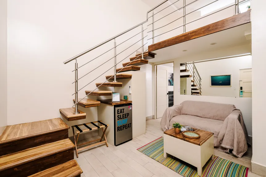 Two-level Surf Loft Suite with wood staircase and lounge area